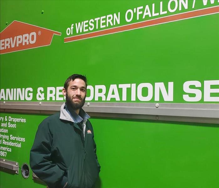 Mark Lane in front of one of our SERVPRO box trucks with our logo, name and number on it.
