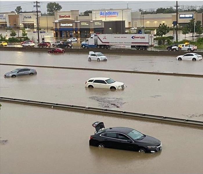 large highway with vehicles at a standstill due to flooding.