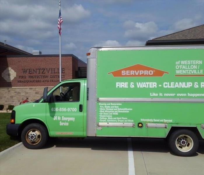a Servpro of Western O'Fallon/Wentzville truck parked in front of the Wentzville Fire House 1.