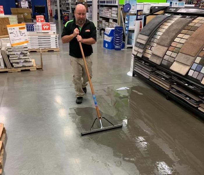 SERVPRO Crew Chief mopping floors at a local store